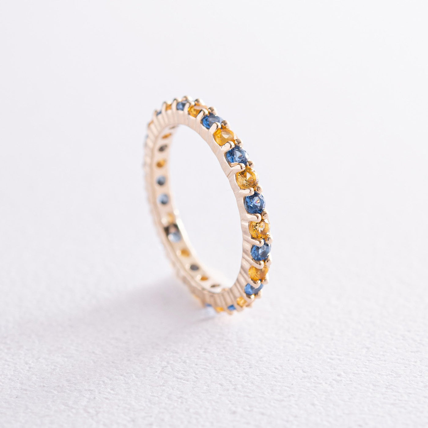 Ring with a path of blue and yellow cubic zirconia