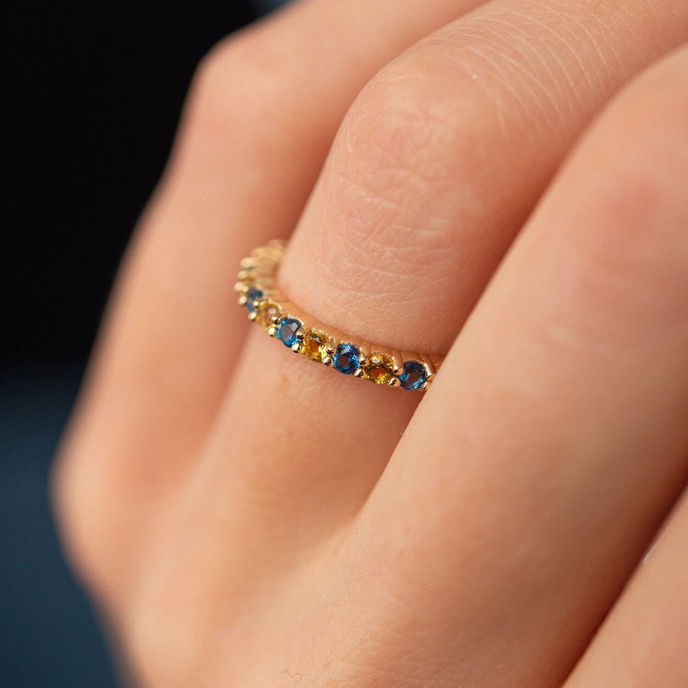 Ring with a path of blue and yellow cubic zirconia