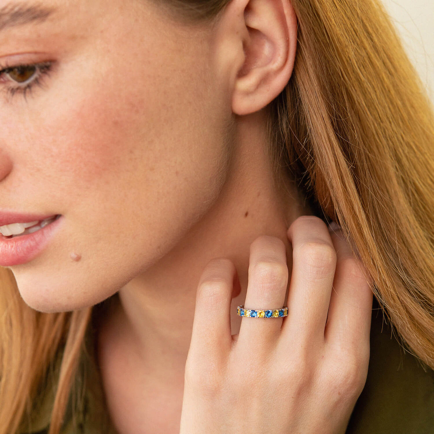 Ring with a path of blue and yellow cubic zirconia