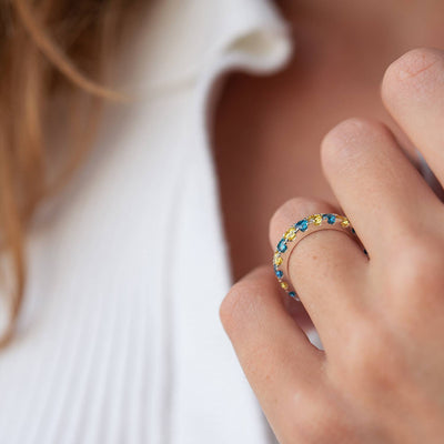 Ring with a path of blue and yellow cubic zirconia